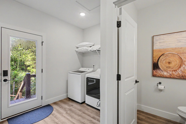 Main level laundry area, powder room, and loft access