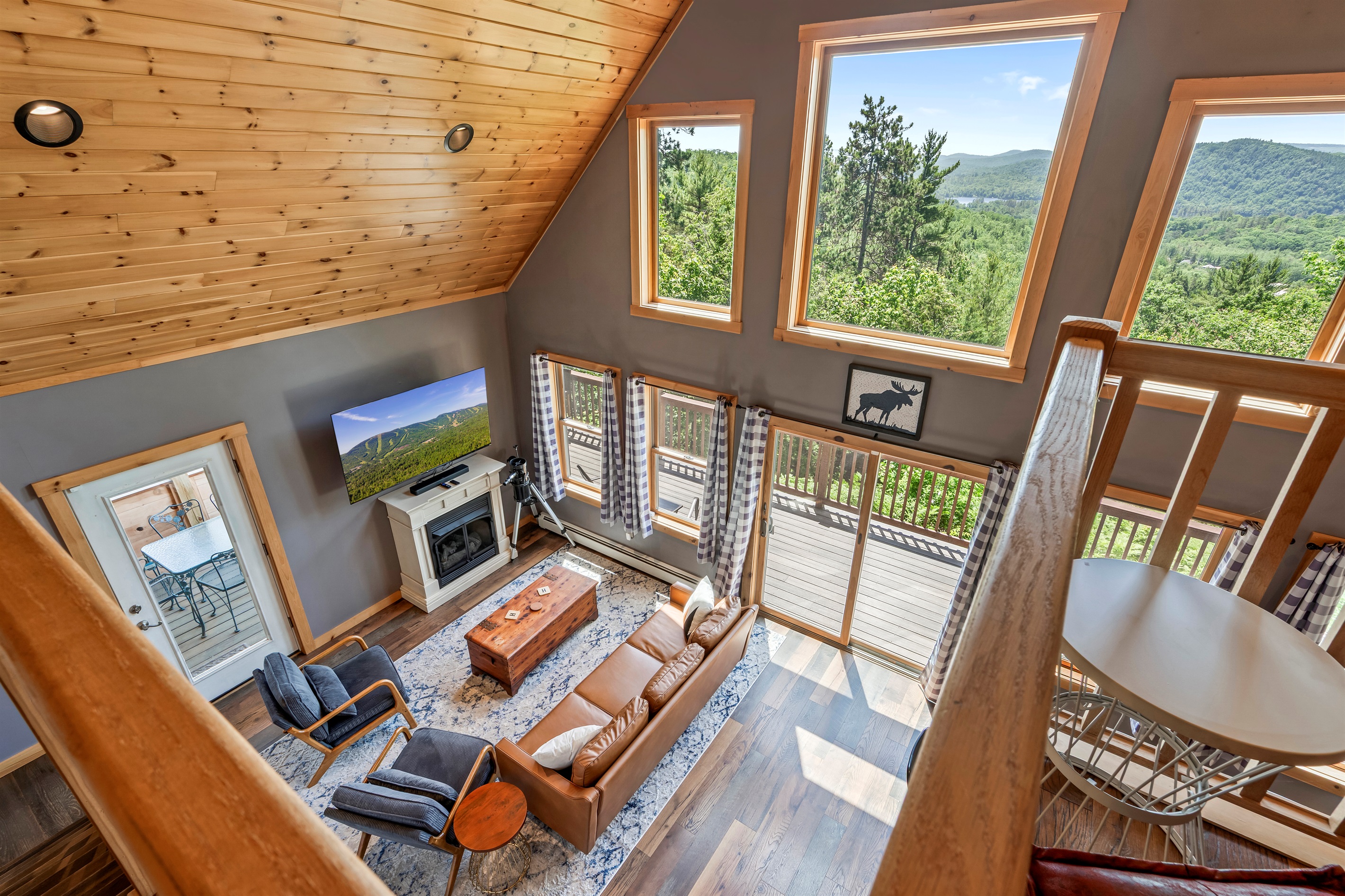 The second floor features a cozy reading loft, the master bedroom with king-size bed and barn door, a work space, and an ensuite bathroom.