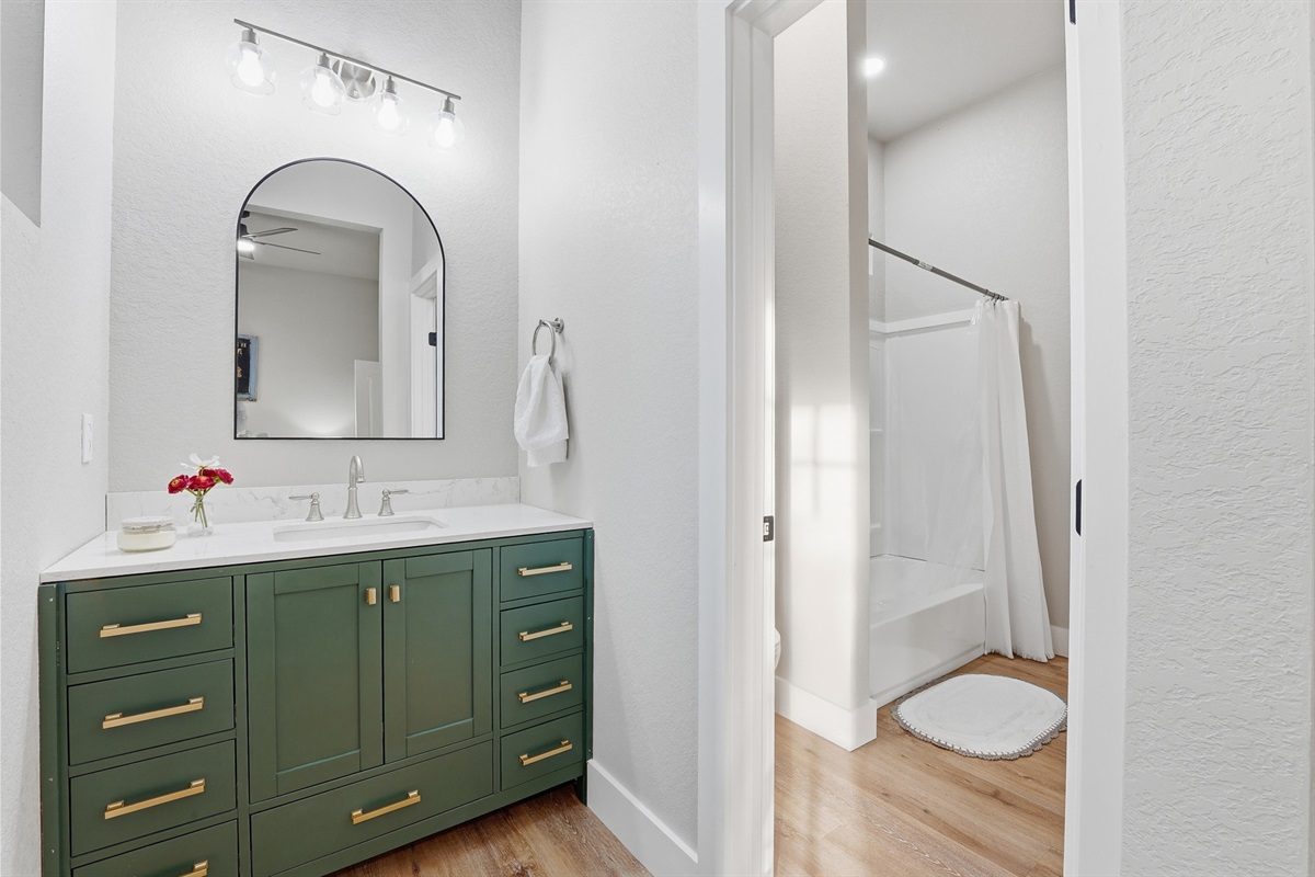 Vanity area connecting Bedroom Two to the shared Jack & Jill bath. The Jack & Jill bathroom has a shower over small bath and toilet 