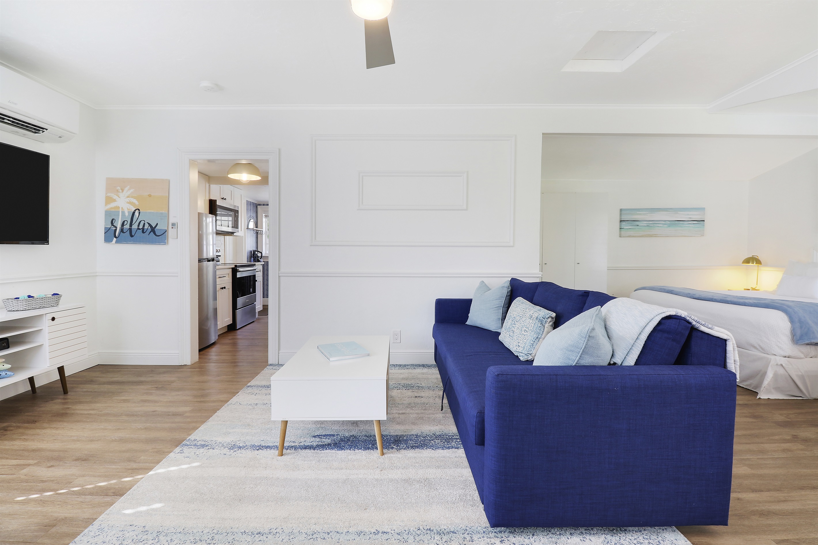 The Cottage House offers a living room area, full kitchen, workspace, a sleeping area with king bed, and a full bath.