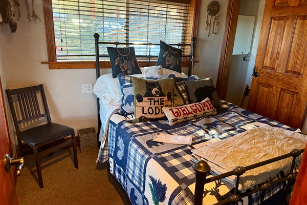 The Dreamcatcher Room - Cozy lodge‑themed bedroom with a full‑size bed, warm wood accents, and mountain‑inspired décor.