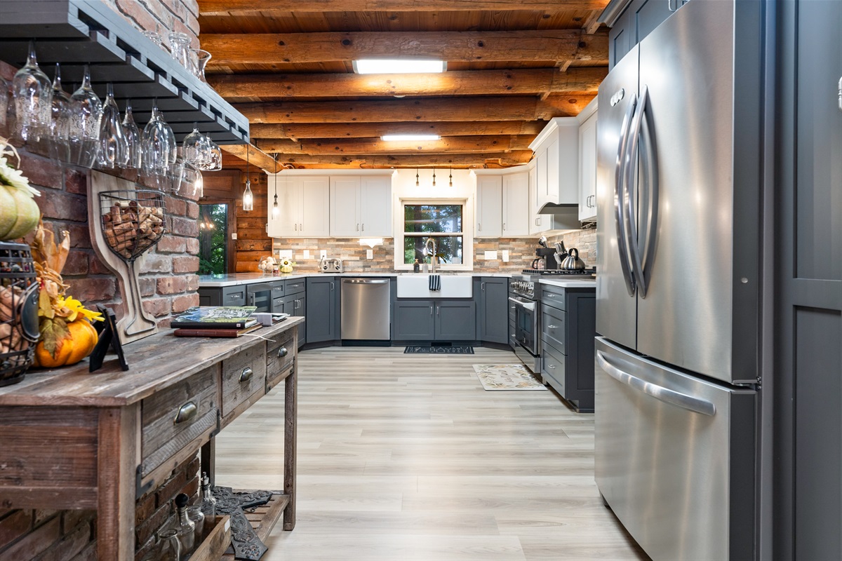 A modern chef’s kitchen with sleek gray cabinetry, wine cooler, and spacious island blending style with convenience.