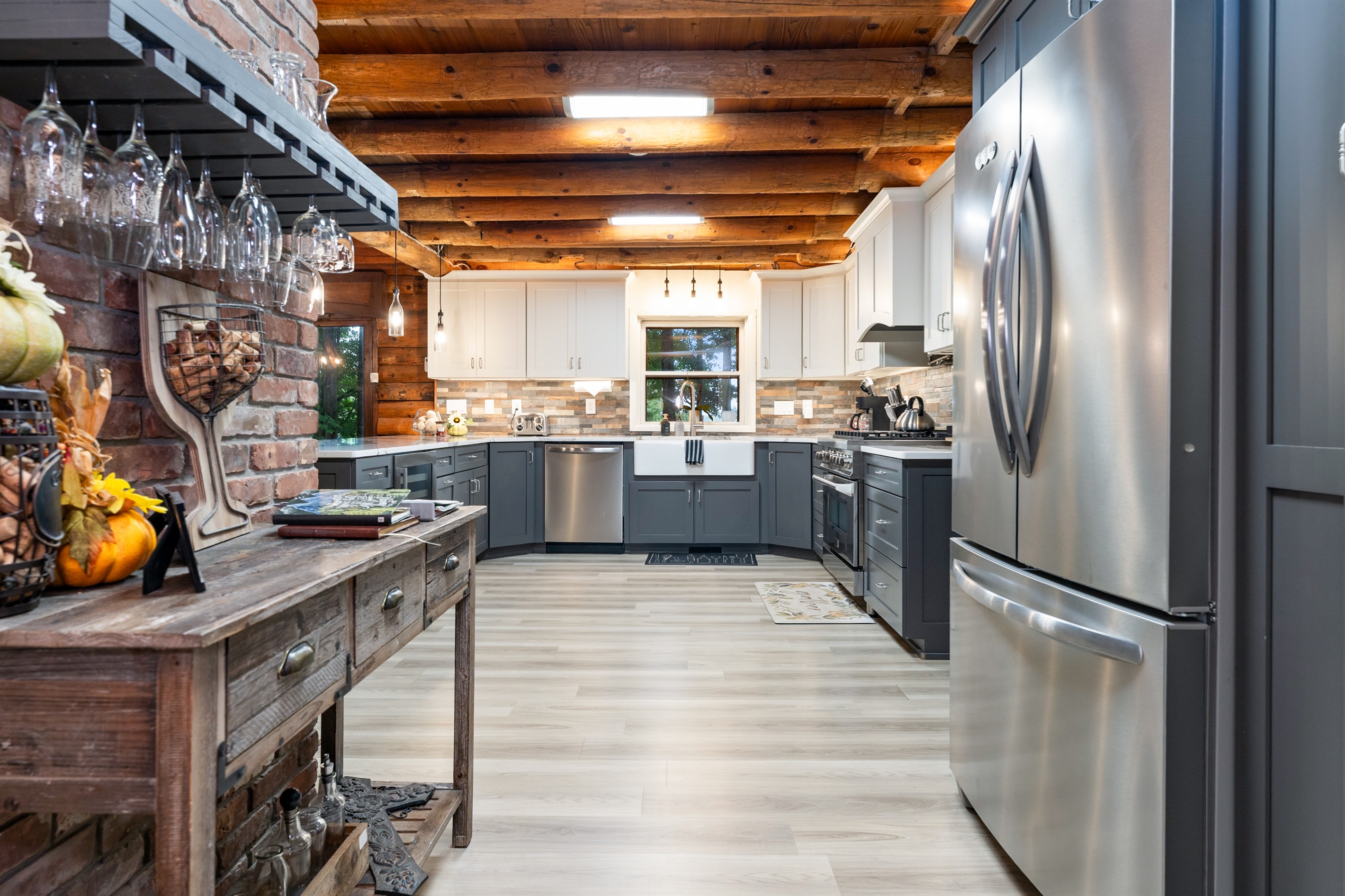 A modern chef’s kitchen with sleek gray cabinetry, wine cooler, and spacious island blending style with convenience.