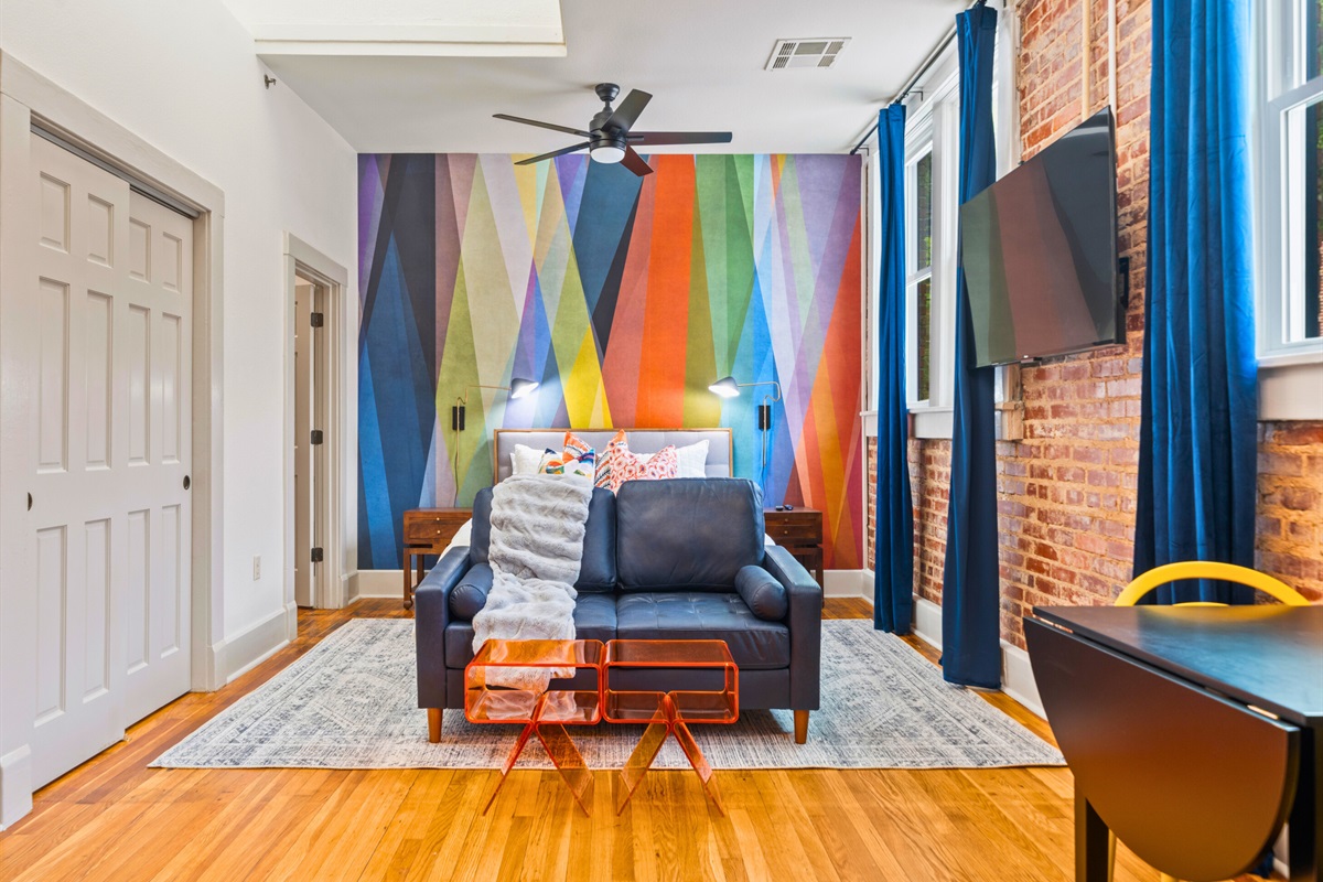 A closer look at the inviting bed setup shows colorful accents and soft linens, ensuring a restful and cozy stay.