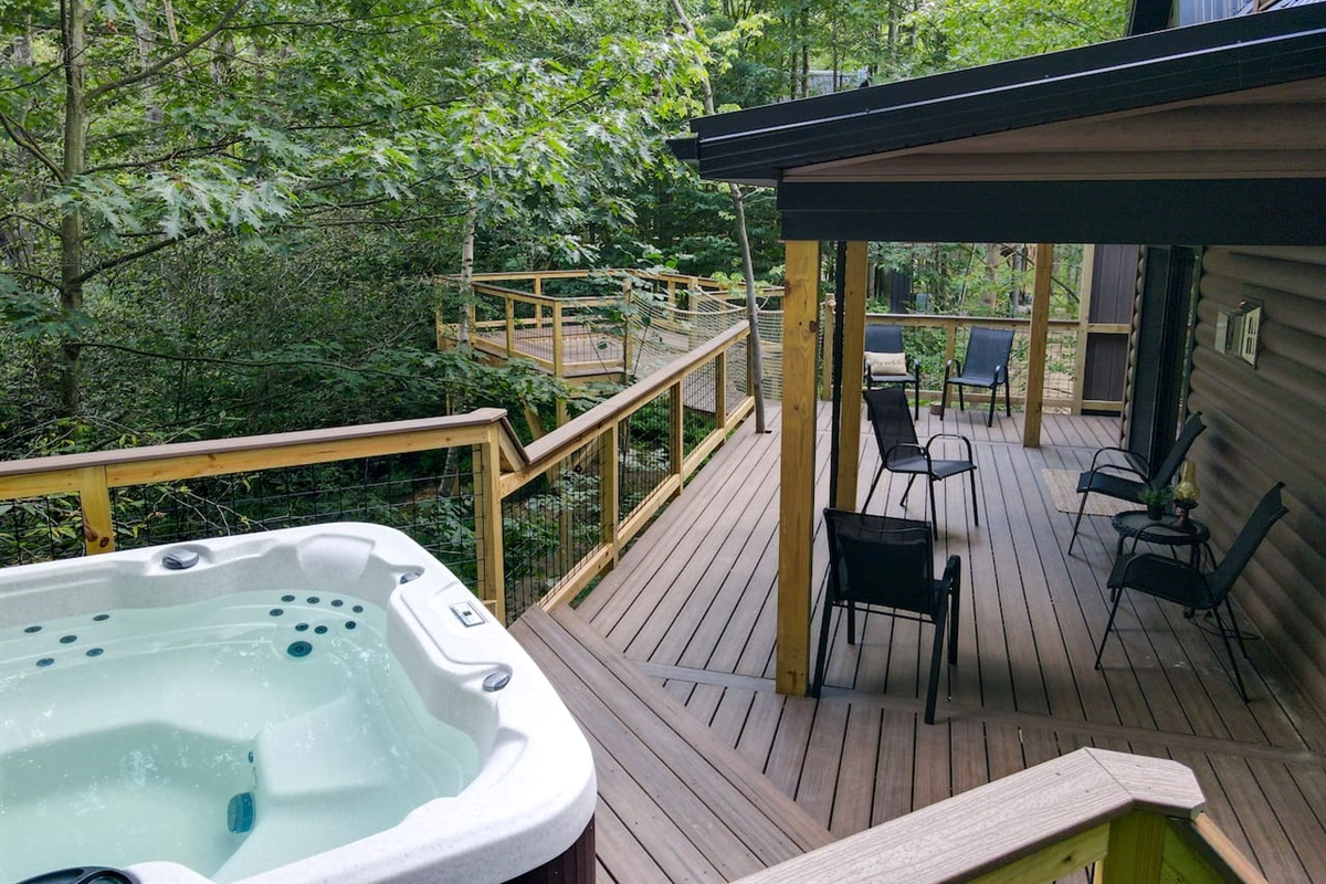 The treehouse deck offers a luxurious outdoor experience with an elevated hot tub & XL hammock seamlessly built into the deck floor. Additionally, you can enjoy the refreshing outdoor shower May 15- October 15. The hot tub is available 365 days 24/7.