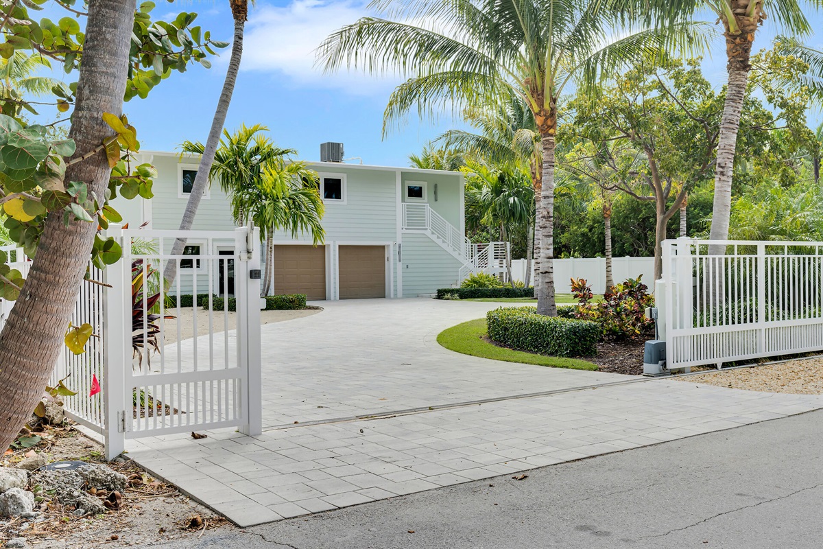 Dual gates to circular driveway provide privacy. The property is completely fenced in. 