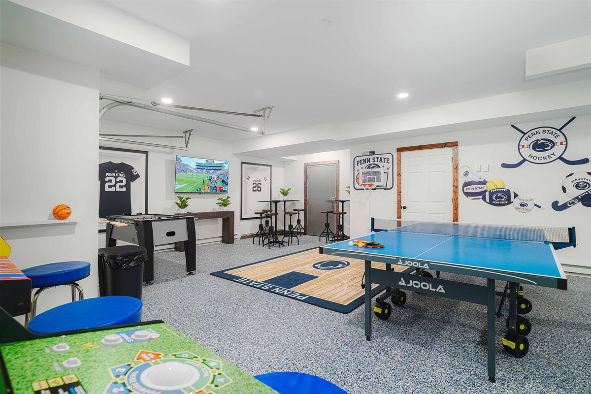Lower-level entertainment hub with ping pong, shuffleboard, TVs, and bar seating — designed for nonstop fun.