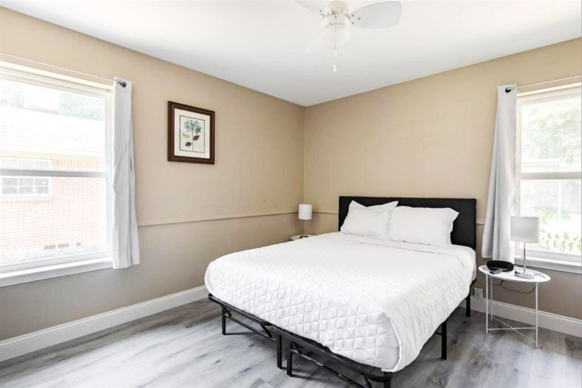 Queen Bedroom 2 with Queen bed, Smart TV, work desk and ensuite full bathroom access.