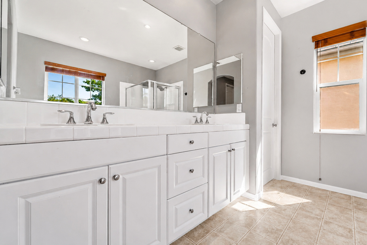 Primary bathroom vanity with double sinks, lots of counter space, and a clean setup for getting ready.