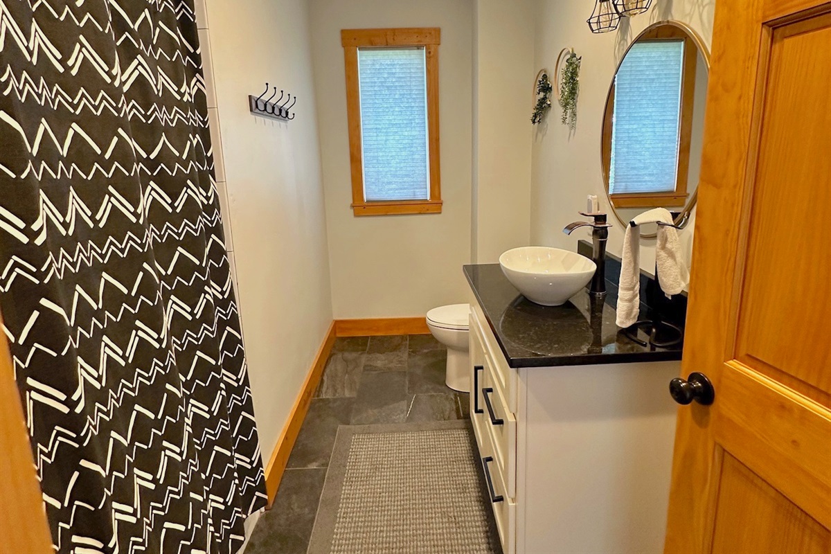 Unit A Enjoy the upgraded fixtures and tasteful decor in bathroom #1.