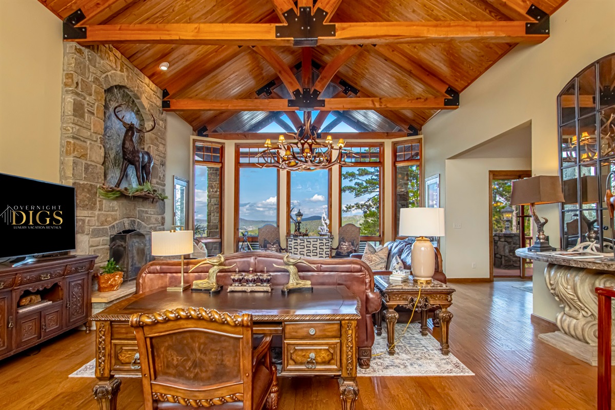 Gorgeous and Rustic Living Room with Exposed Wood Ceiling and Brick Fireplace