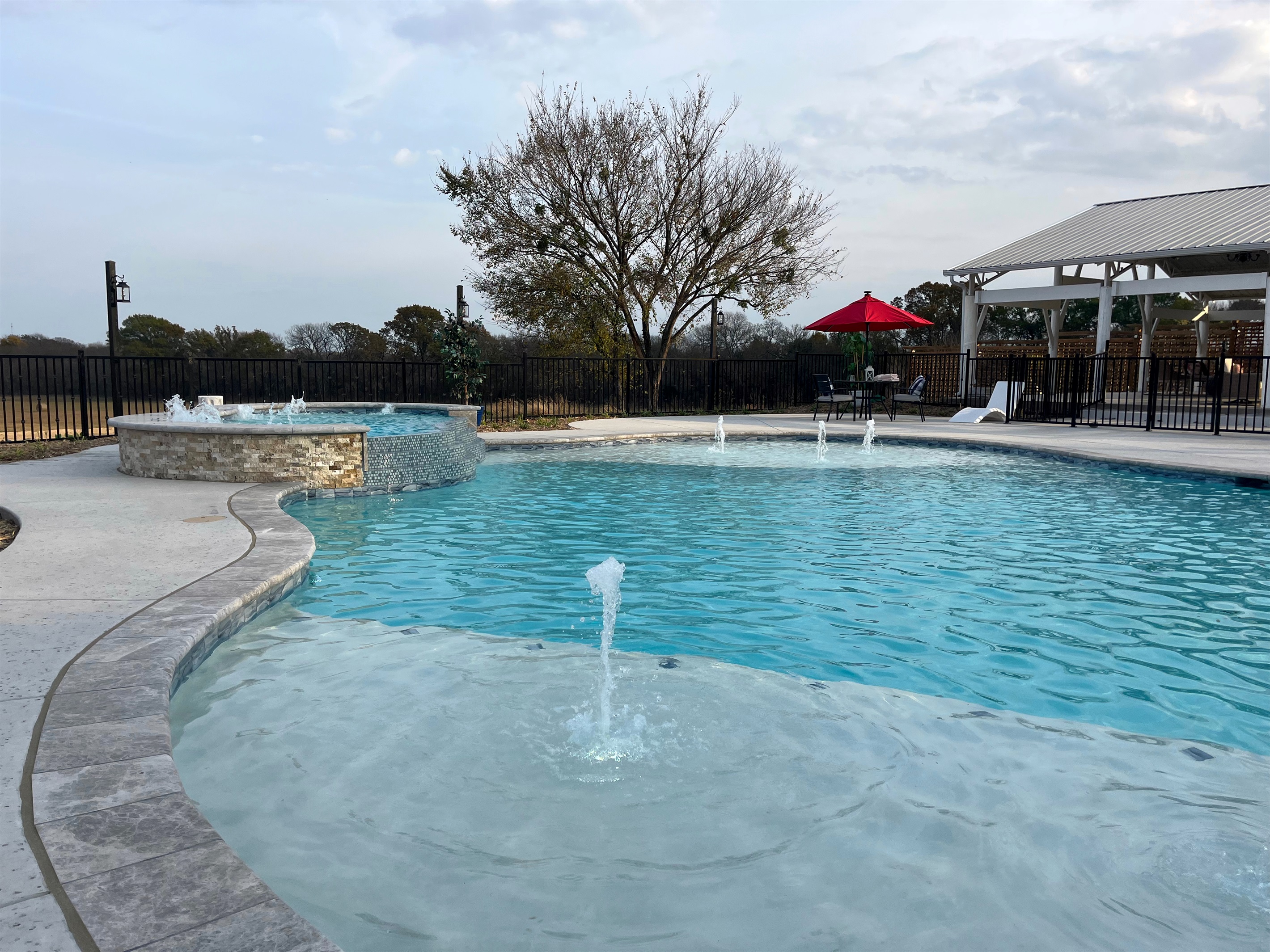 Resort style 30,000-gallon saltwater pool with double waterfalls and grotto and slide