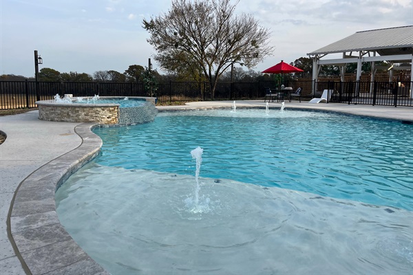 Resort style 30,000-gallon saltwater pool with double waterfalls and grotto and slide