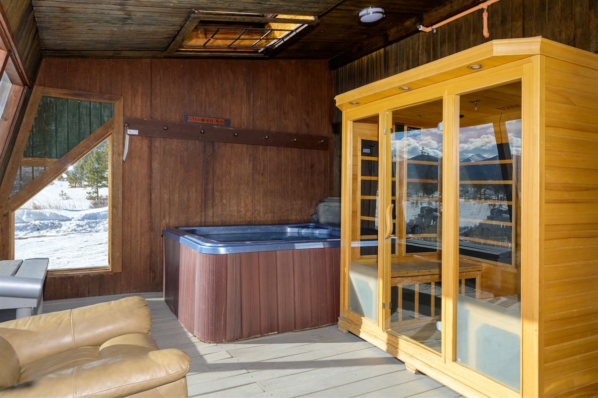 Sauna and indoor hot tub in sun room facing the resort