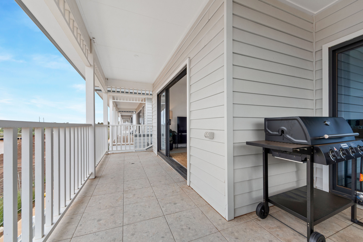 Gas BBQ on the covered balcony, handy for outdoor cooking, with sliding doors back into the living area.