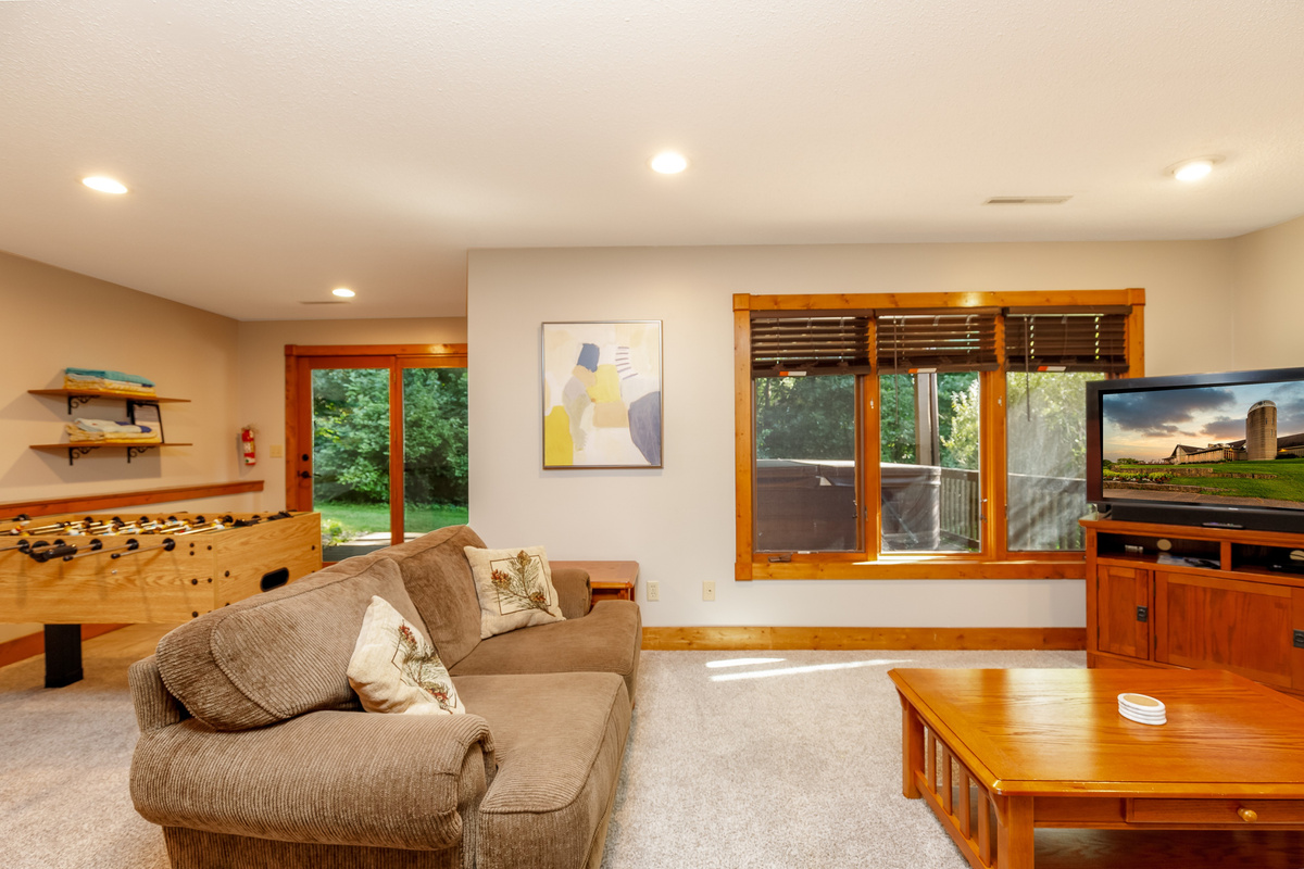 Lower level living room with sleeper sofa, Roku Smart TV, foosball, and pac-man!