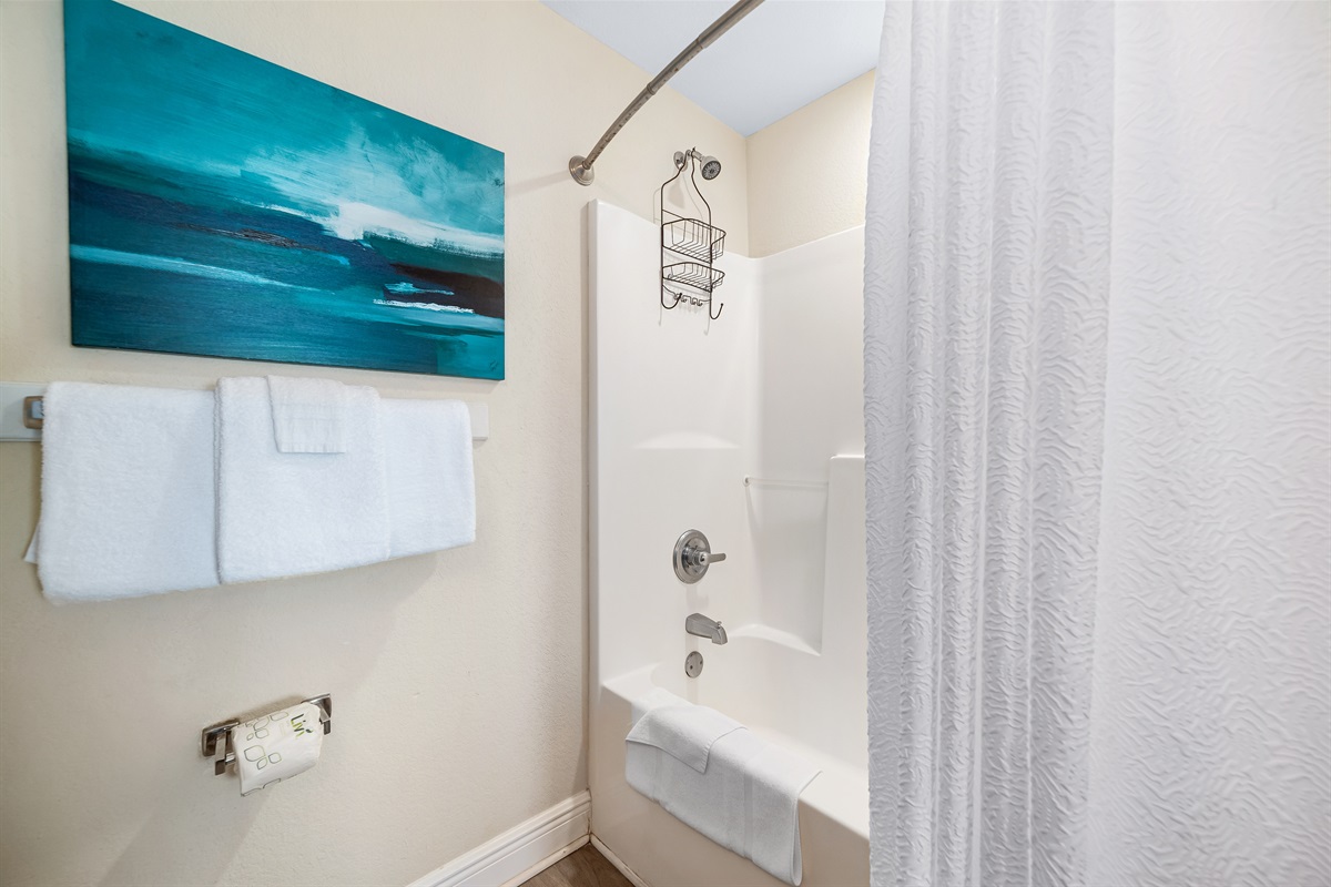Designed for convenience, this bathroom boasts double sinks and shower/tub combo, making it ideal for shared use.