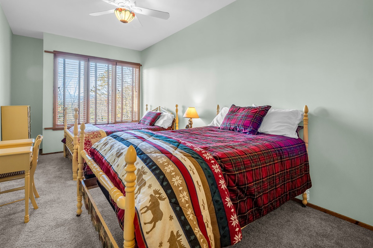 Downstairs bedroom with two full beds.