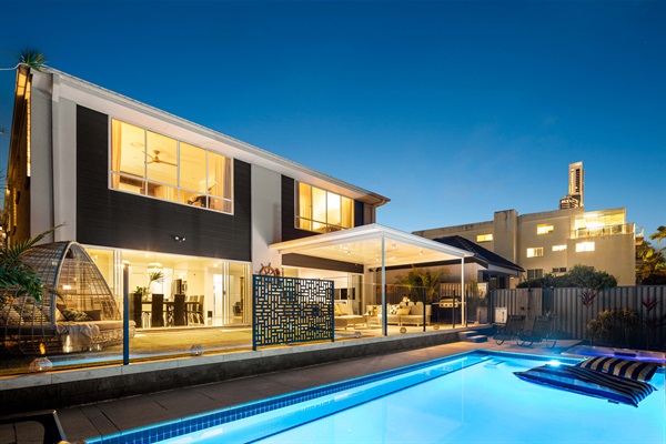 Luxury waterfront living in Surfers Paradise - illuminated pool, expansive entertaining spaces, and private canal frontage.