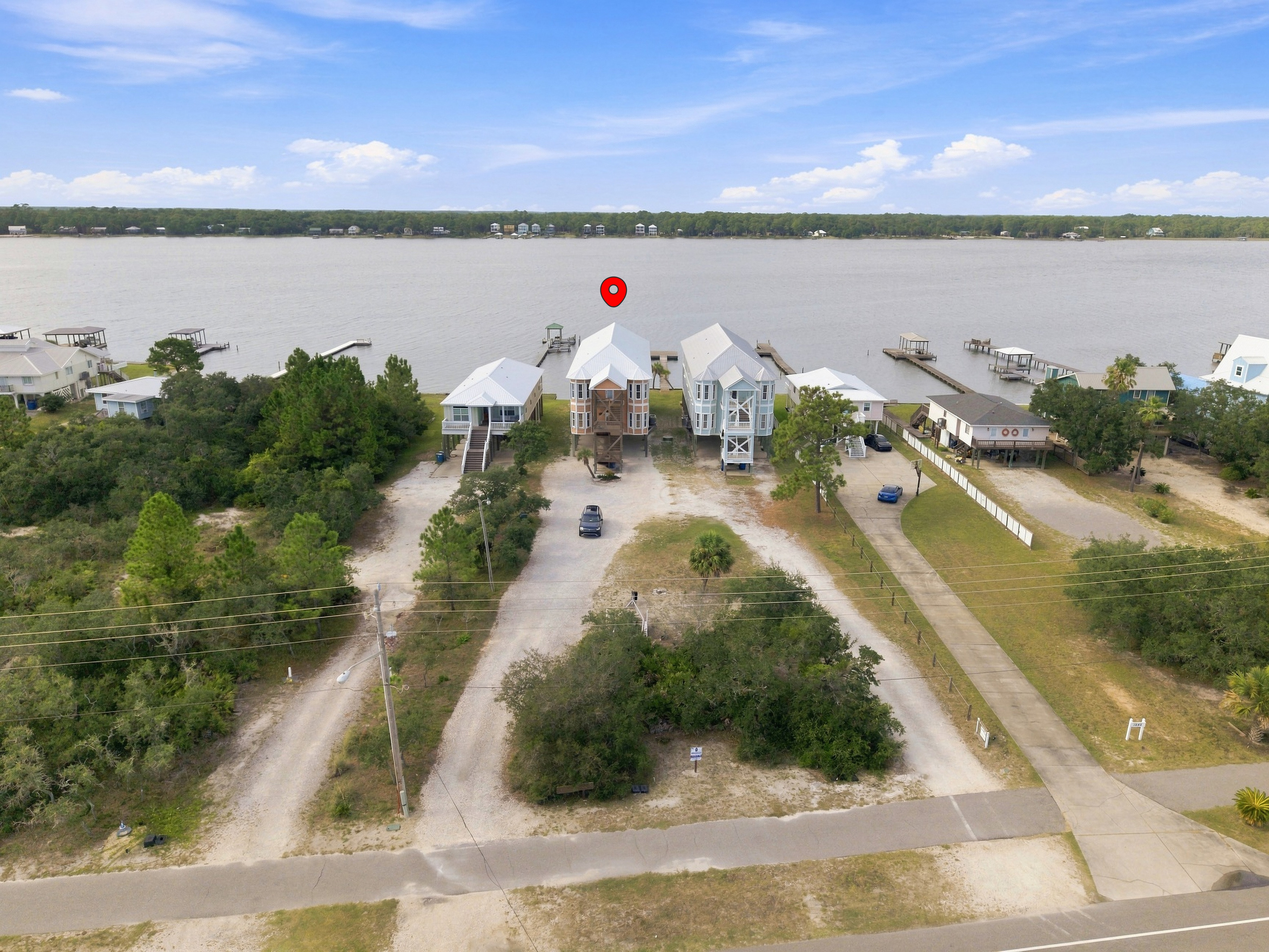 Aerial view of the home with ample parking and water access