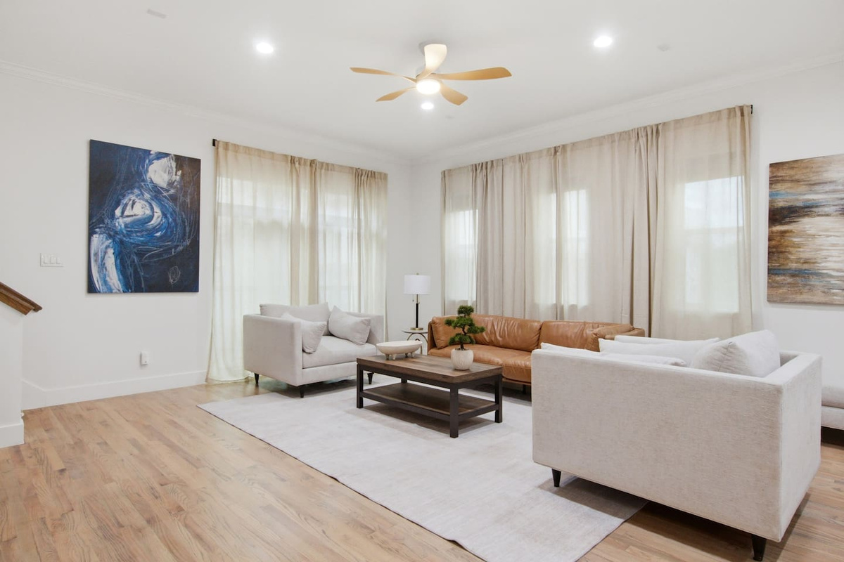 Living area with Smart TV, ceiling fan, and modern sectional seating. A comfortable space to decompress, catch up on a show, or regroup before the next outing in Dallas.
