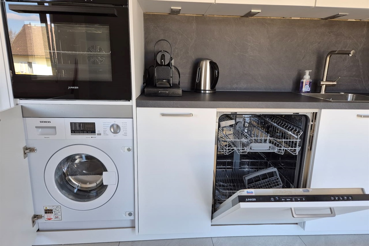 In the kitchen there is a dishwasher, a washer/dryer combination, coffee maker (Nespresso), kettle, oven, microwave, fridge and induction stovetop