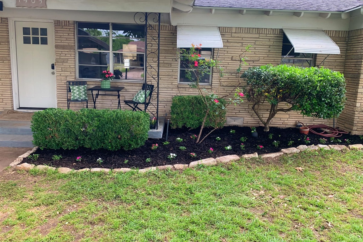 Cutest front porch and fresh flower beds