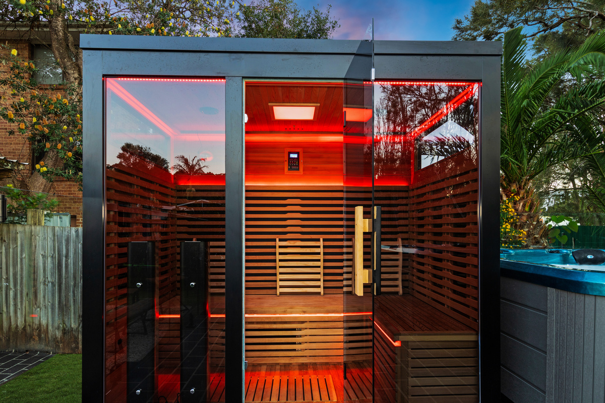 Skye’s Beach House includes a 5-person outdoor infrared sauna with red light therapy, positioned within the backyard wellness area.