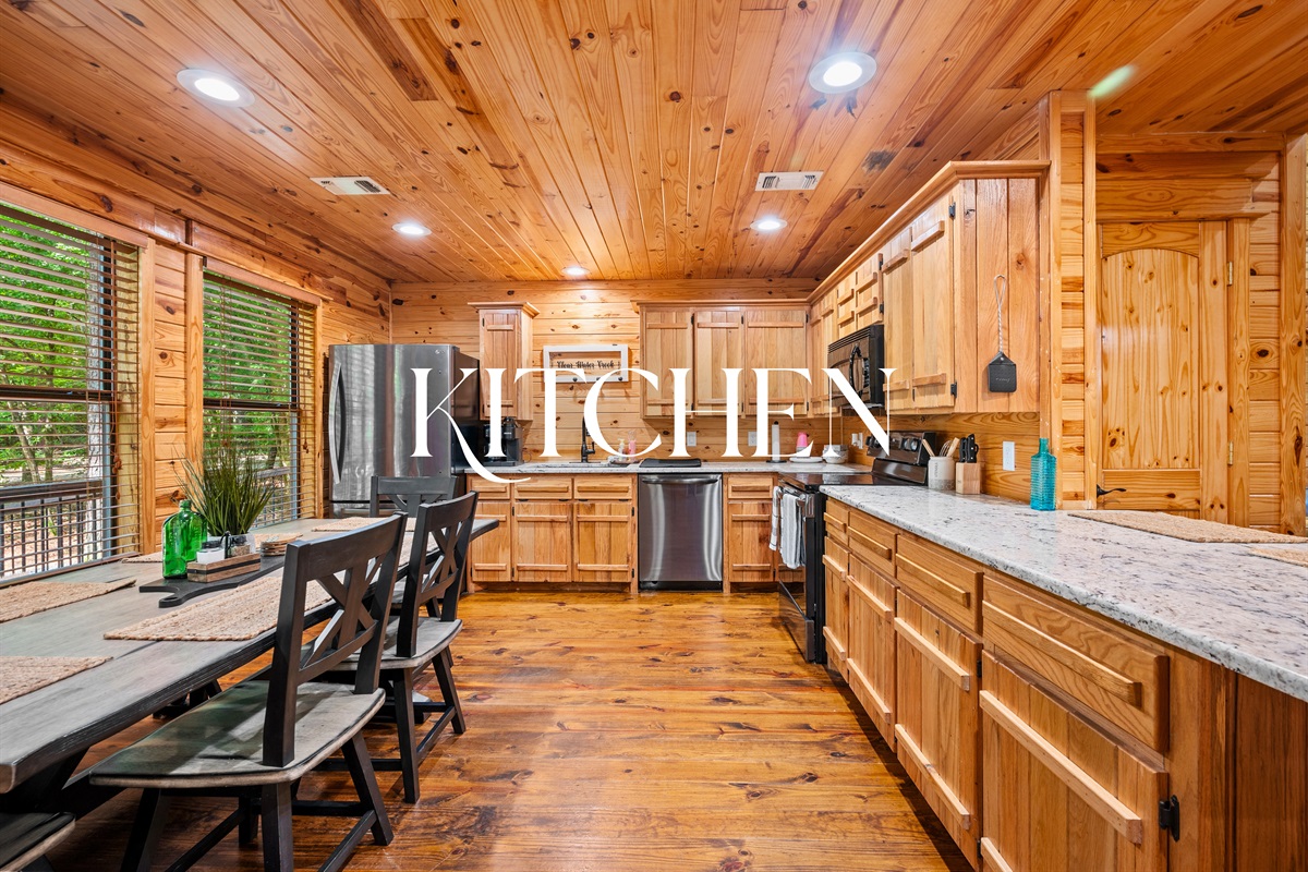 Rustic-style kitchen with granite countertops, full appliances, and a dining area for home-cooked meals with family or friends.