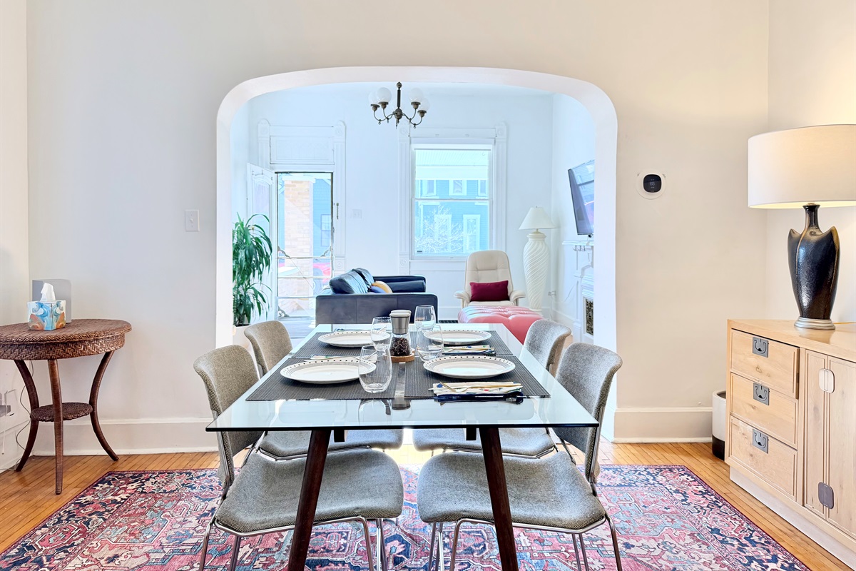The dining area flows seamlessly into the living room, where a wall-mounted flat-screen TV can be angled for easy viewing from both spaces.