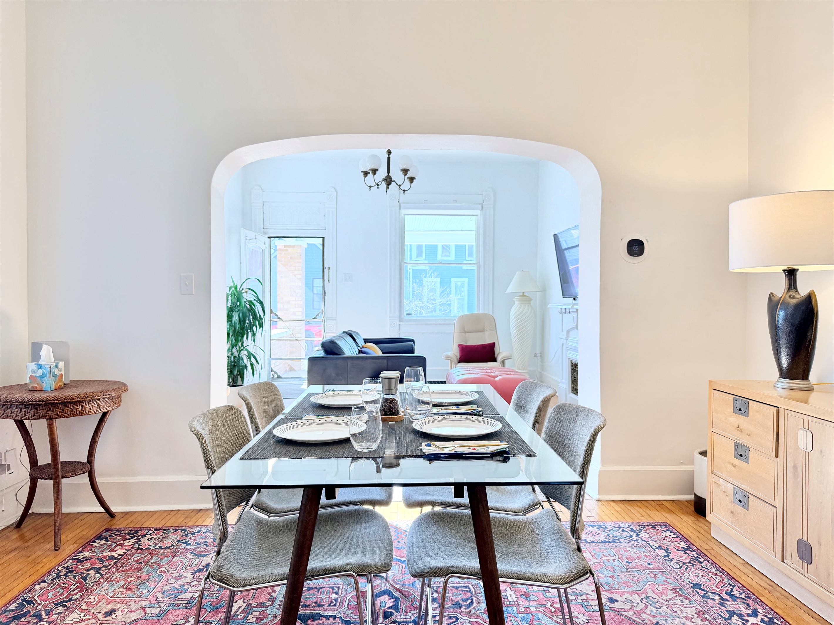 The dining area flows seamlessly into the living room, where a wall-mounted flat-screen TV can be angled for easy viewing from both spaces.