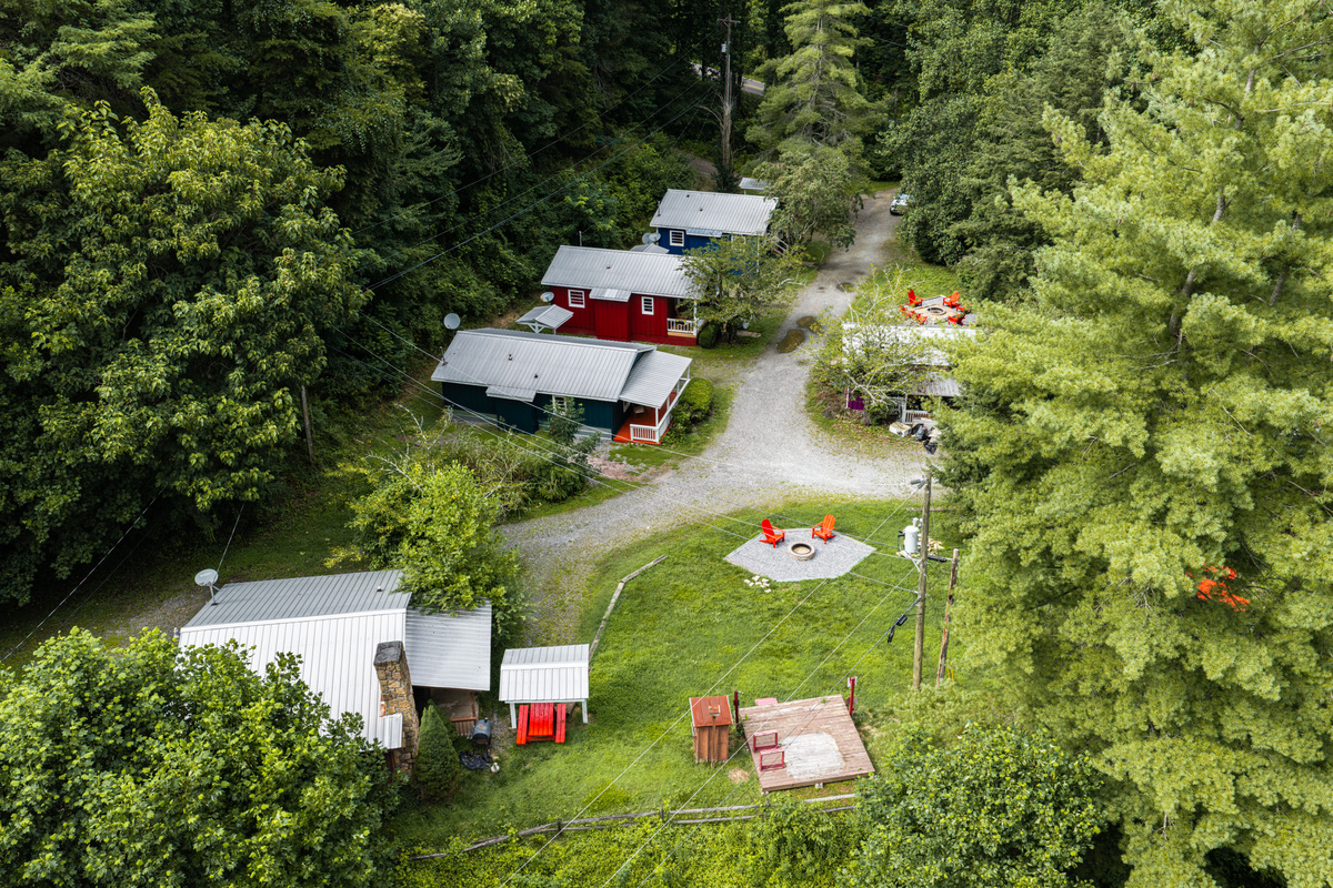 Charming Cabin Community: Experience tranquility surrounded by lush greenery and vibrant colors!