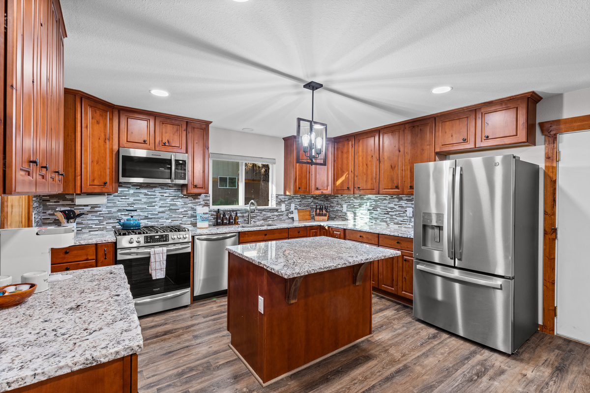 Kitchen with oven, island and refrigerator
