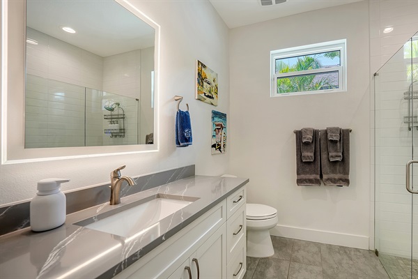 Backlit vanity and spa-quality bath products in the 2nd bathroom in between the two Queen bedrooms