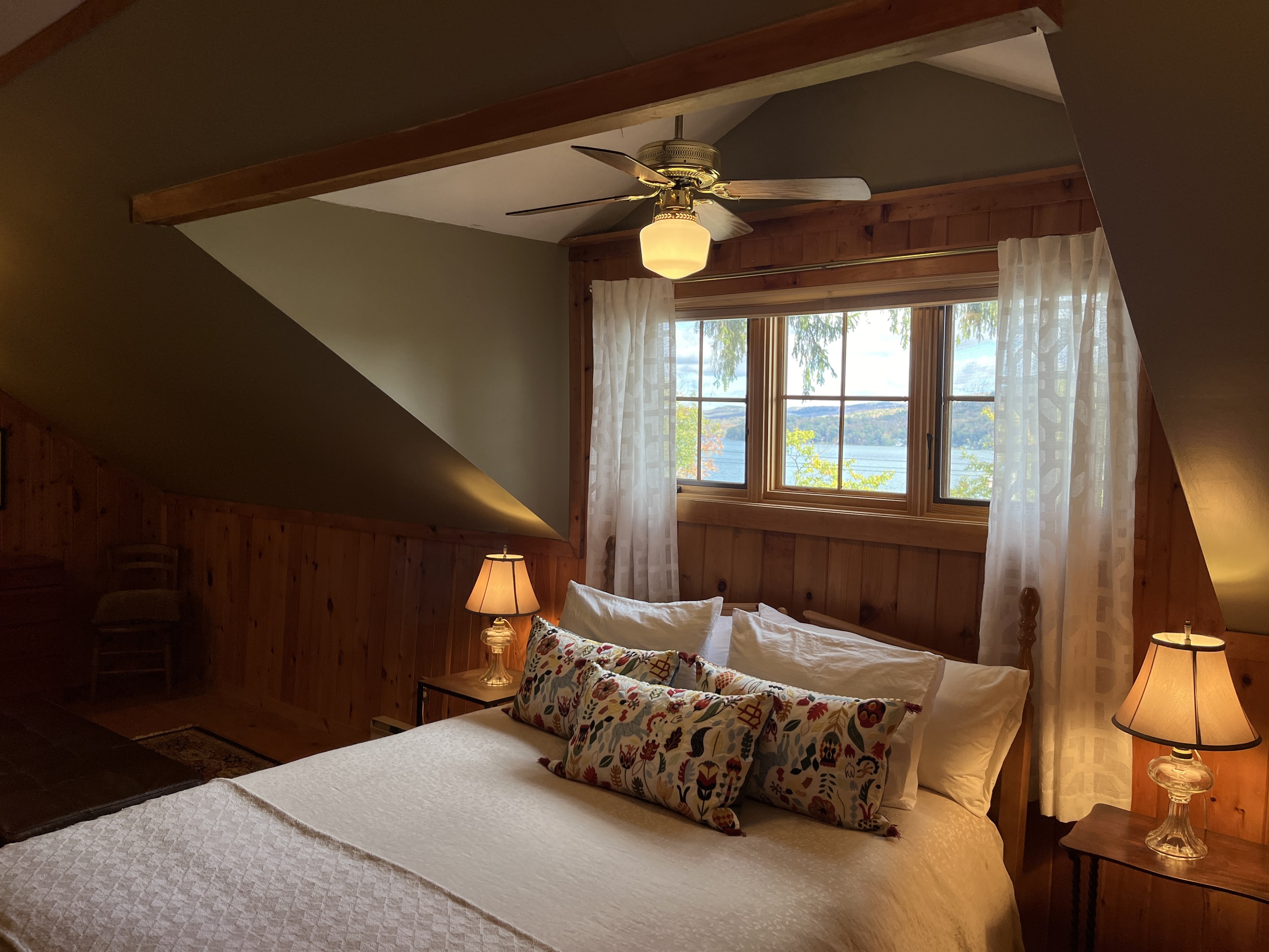 Lille Gossebo 2nd floor primary bedroom with amazing lake view as a headboard.