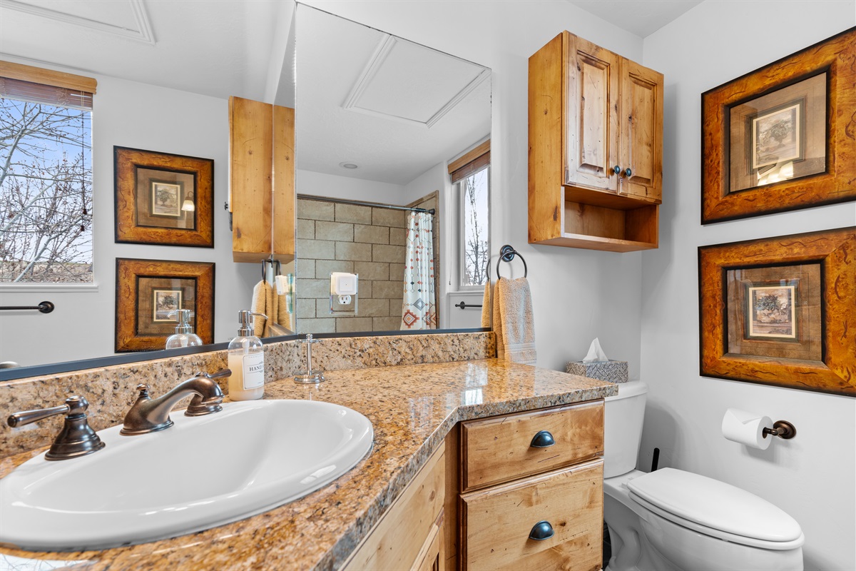 Spacious ensuite vanity with generous counter space and warm wood finishes.