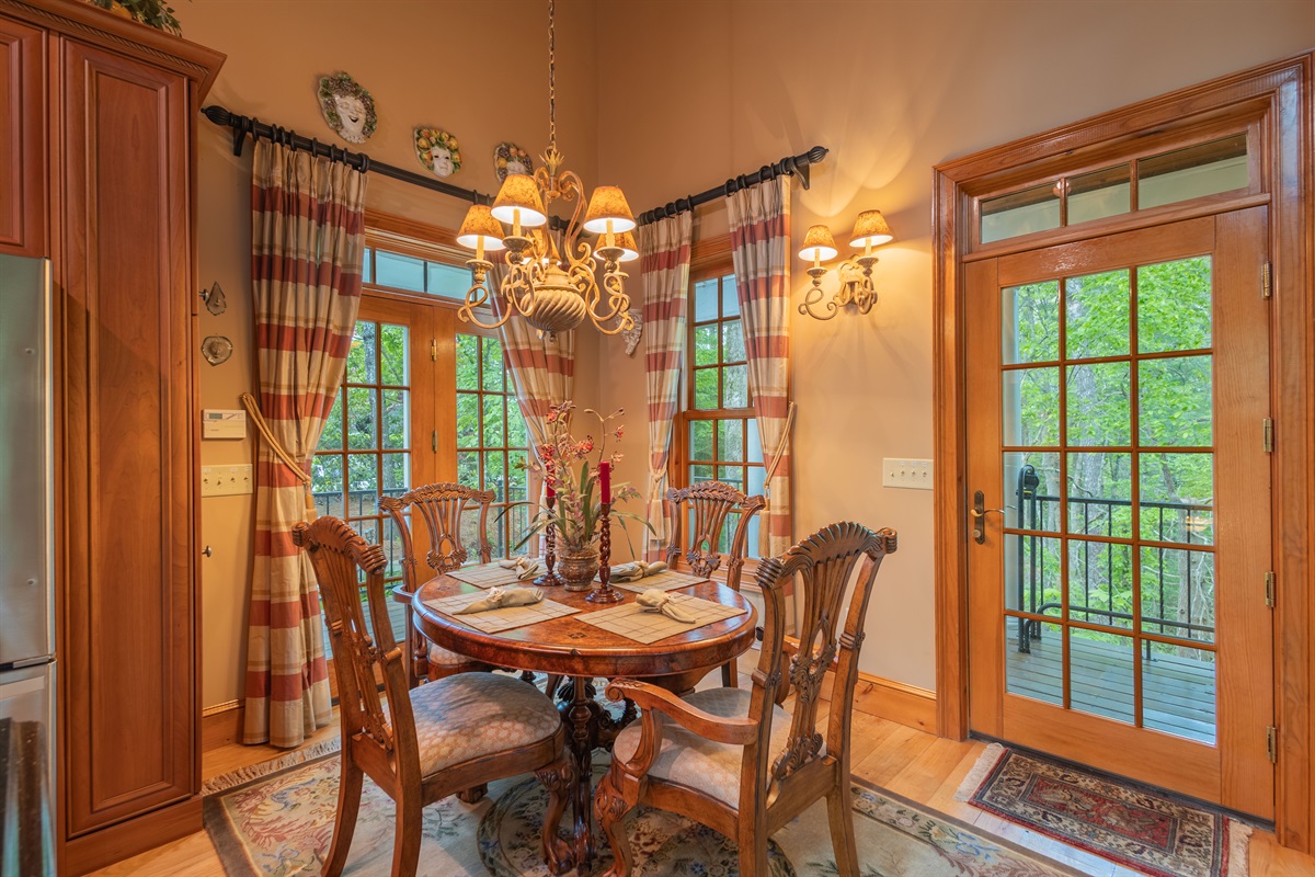 Enjoy meals together in the warm and inviting dining area, perfectly positioned within the open-concept living space beneath beautiful vaulted ceilings.