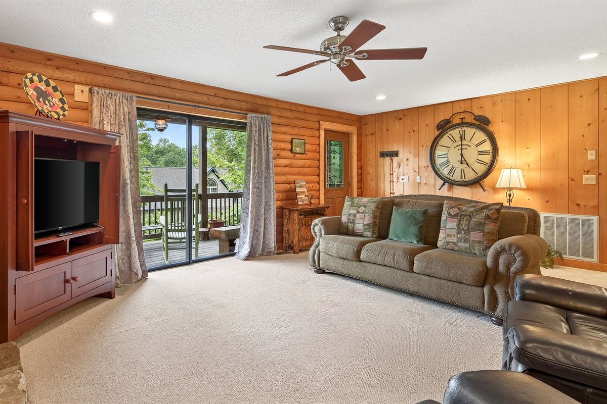 Sliding glass doors lead to the large, wrap around deck