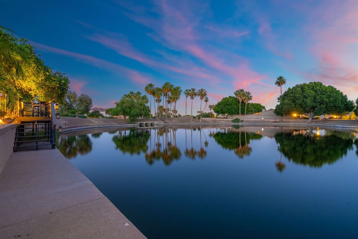 The lake mirrors the last colors of the evening sky in perfect stillness — a nightly show of natural beauty right outside your door.
