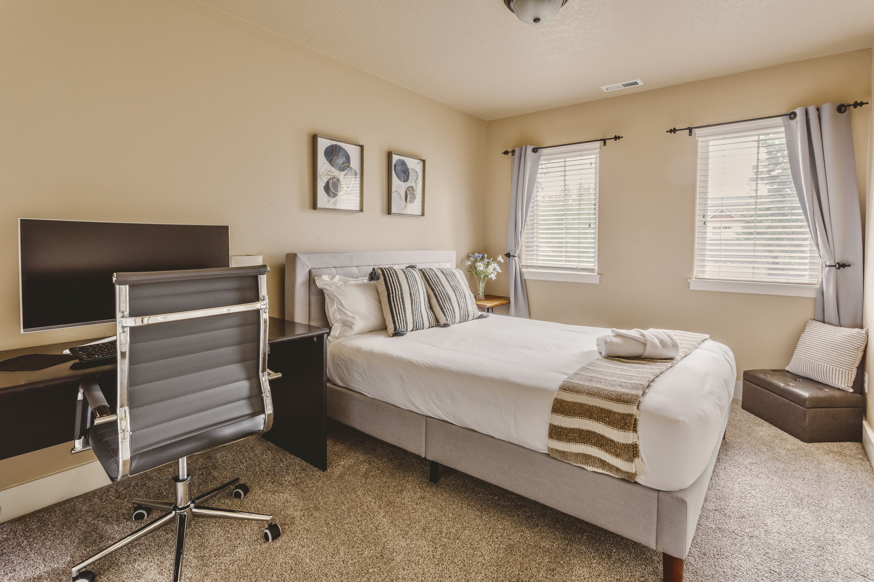The queen bedroom includes a dedicated office desk setup.