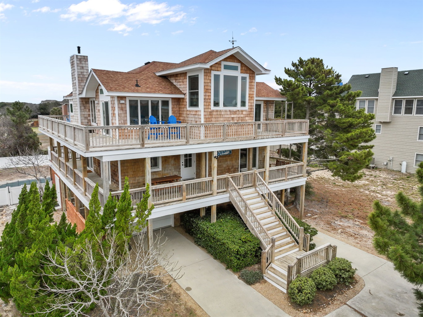 Front exterior with wraparound porches and a welcoming entry.