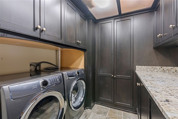 Basement - Laundry room with washer, dryer, folding counter, and mini fridge.