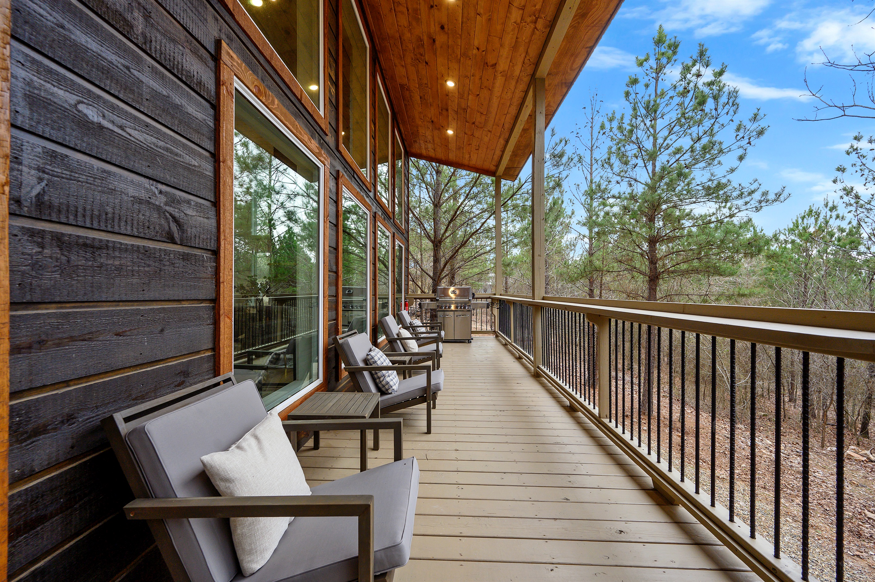A relaxed outdoor seating spot just outside the cabin, featuring comfortable chairs where you can sit back, take in the surroundings, and enjoy the calm, open-air atmosphere.