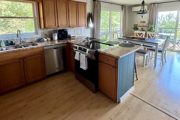 Our kitchen is stocked & we've cooked Thanksgiving for 10 here! Enjoy views, large pantry, stainless range & dishwasher, double sinks, fridge, microwave, lots of bakeware & serving pieces.