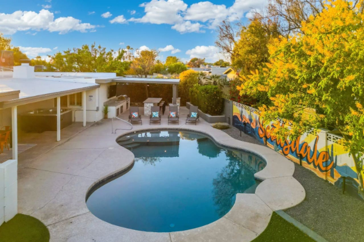 From above, the pool's curved shape and shaded patio come together into one seamless outdoor living space.
