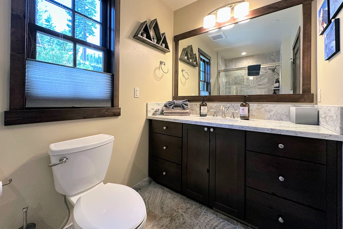 Conveniently located on the main floor, this full bath with tub/shower combo serves both the living area and bunkroom—perfect for freshening up after a day of adventure.