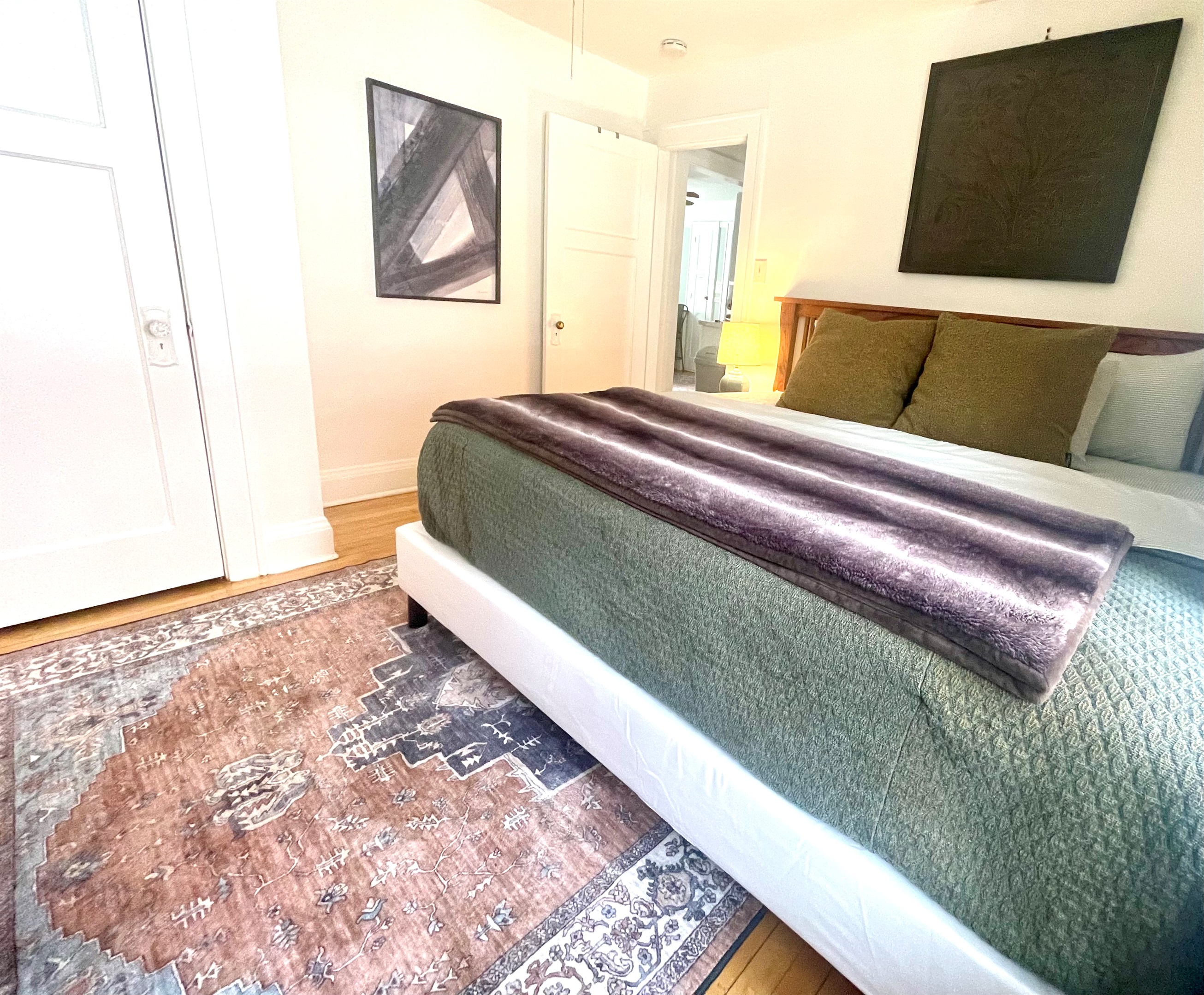 King bedroom with plush bedding, layered textures, and warm lighting—an inviting retreat for deep, restful sleep.