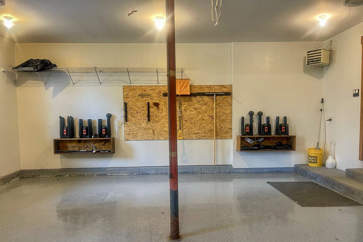Two car garage with boot warmers and gear racks.