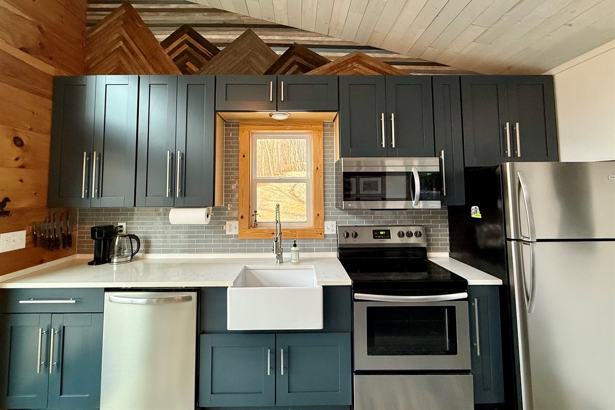 Full-size stainless appliances, soft-close cabinets, and everything you need to cook comfortably- small space, big function.