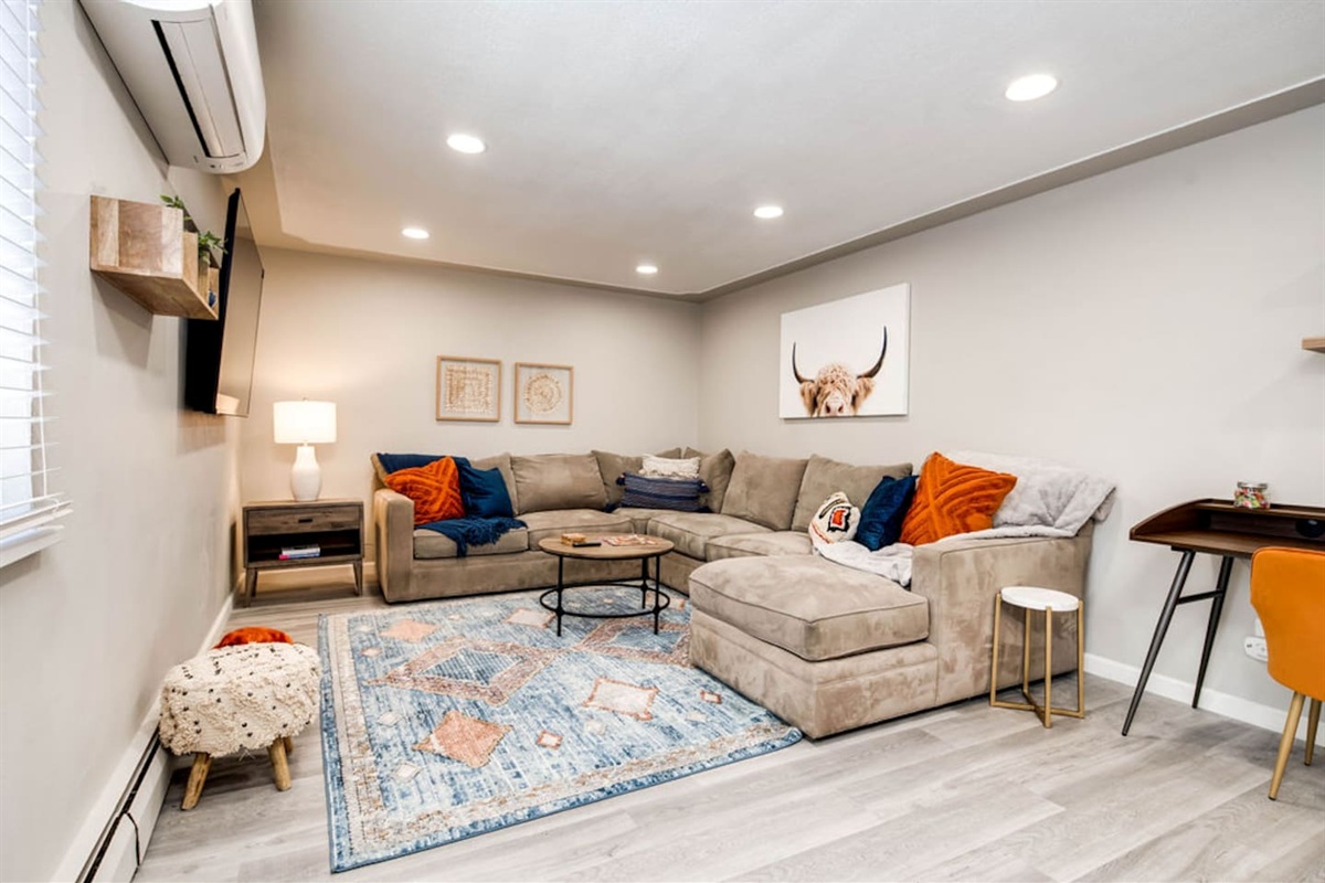 Large living room with sectional and smart TV with plenty of app options